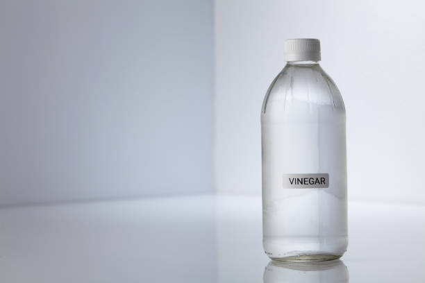 Bottle of white vinegar on gray white background