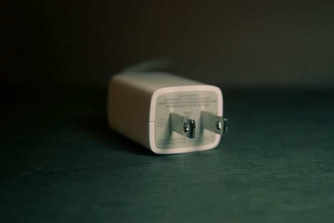 shallow focus photography of white travel adapter