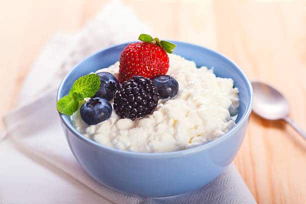 Close-up of homemade cottage cheese with strawberry, blueberries and blackberry, horizontal stock photo