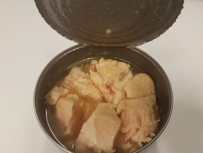 an opened can of canned chicken with broth