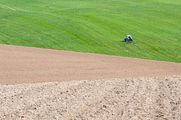 farmer plowing the field - abstract landscape in Austria
