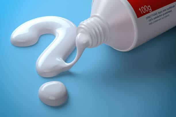 Toothpaste in the shape of question mark coming out from toothpaste tube. Brushing teeth dental concept. 3d illustration