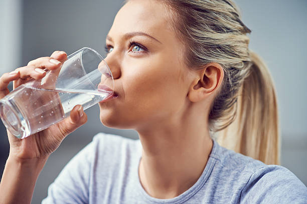 Young woman drinking purified water